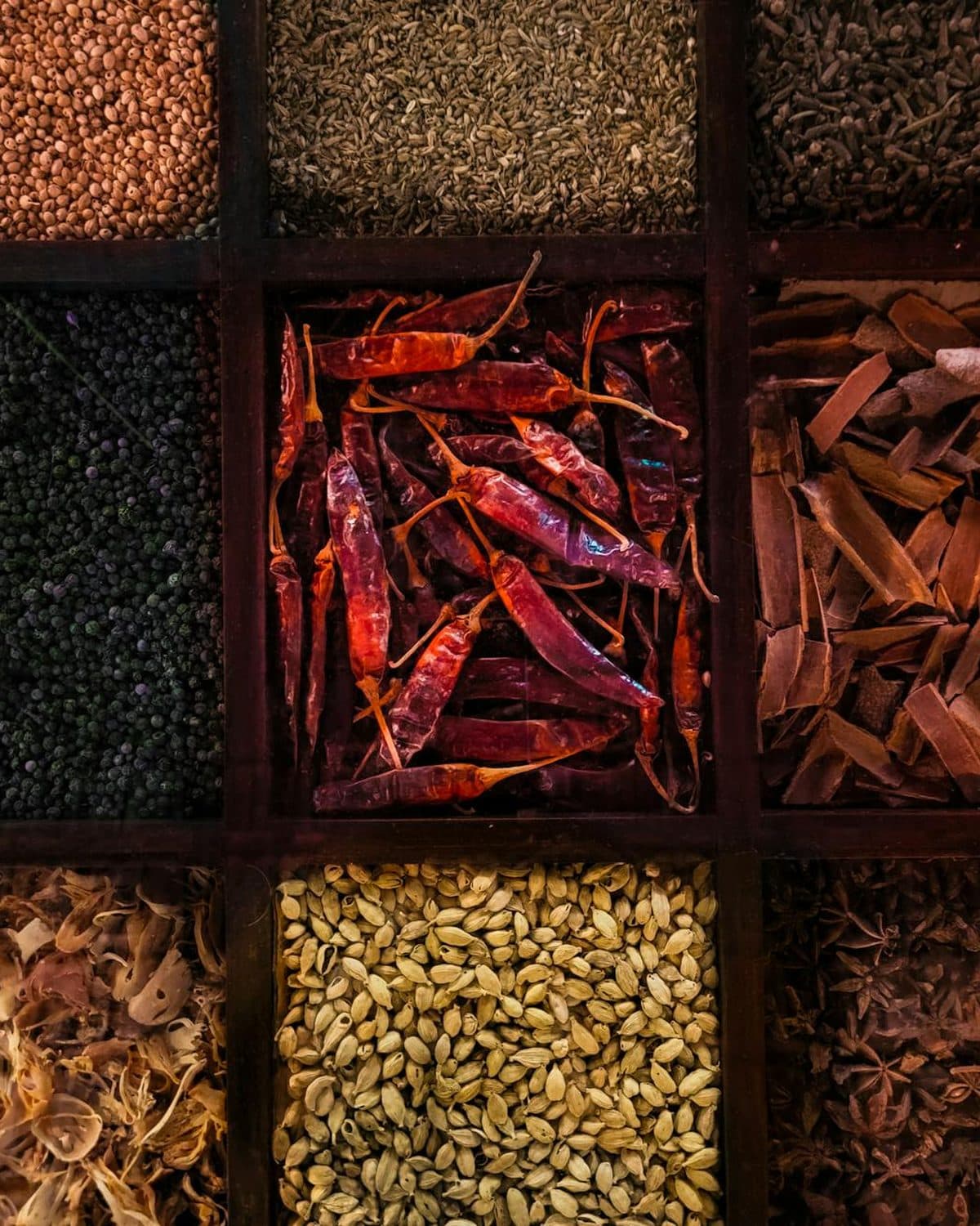 A spread of CaCu bowls, small plates, and chai on a wooden table
